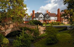 Tudor style houses, a small bridge and trees